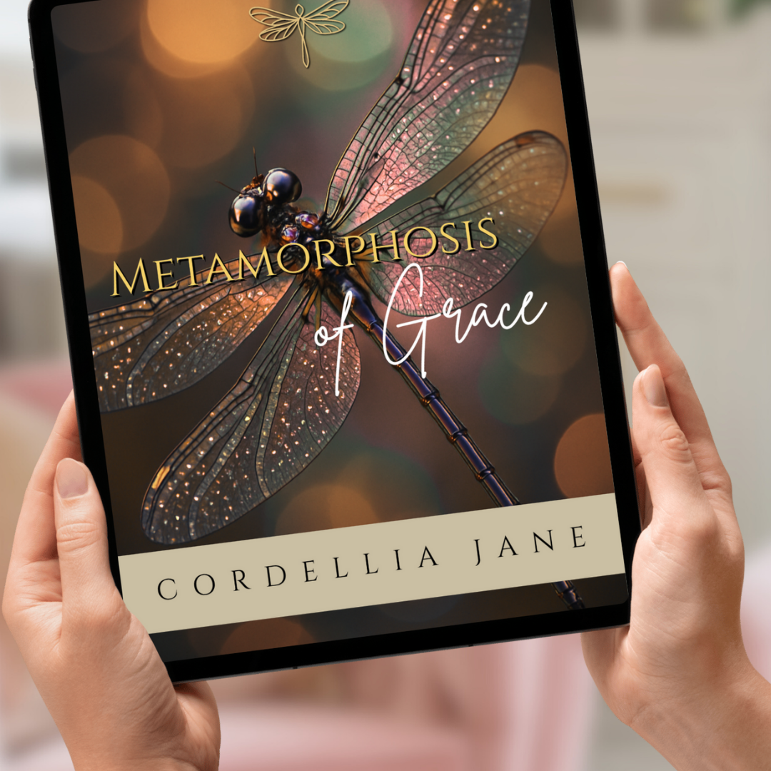 Woman holding a tablet with 'Metamorphosis of Grace' by Cordellia Jane on the screen.