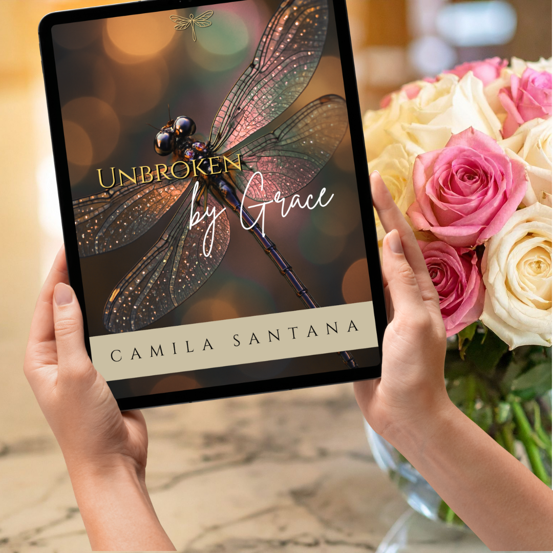 Woman holding a tablet with 'Unbroken by Grace' by Camila Santana on the screen.